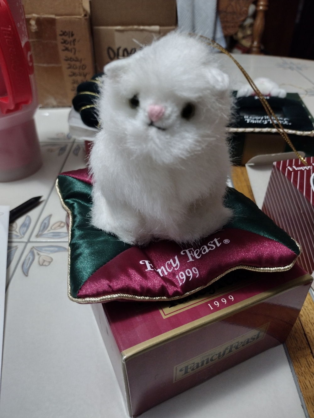 Collectible Fancy Feast 1999 White Plush Cat Ornament on Green & Burgundy Pillow